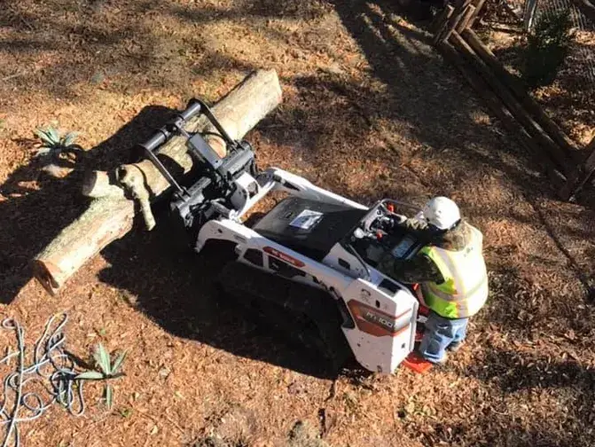 Worker Operating Mini Skid Steer Loader.