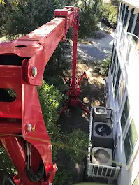 Red Crane Near Building And Air Conditioners.